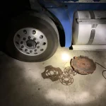 a wheel and metal objects on the ground