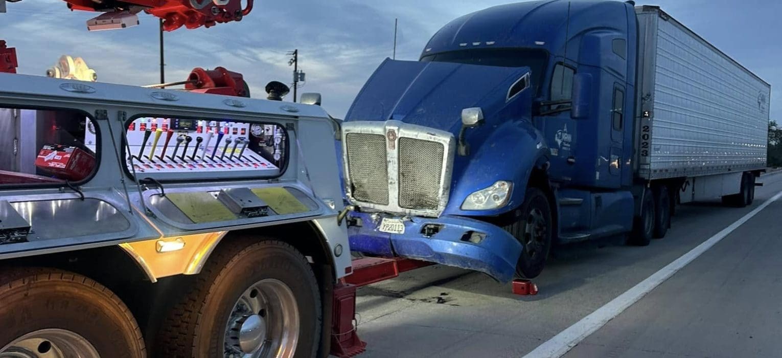 a truck with a broken bumper on the side of the road